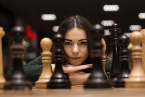 A woman looking over a chess board