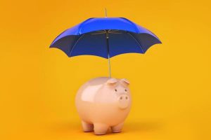 A blue umbrella sheltering a pink piggy bank